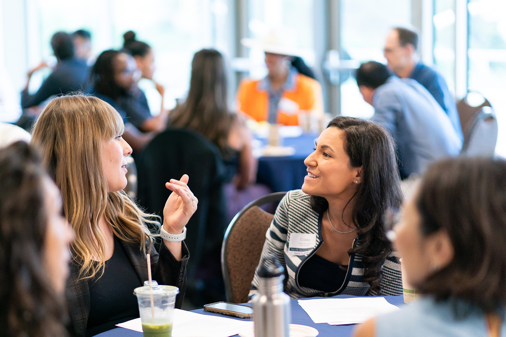 four seated people talking