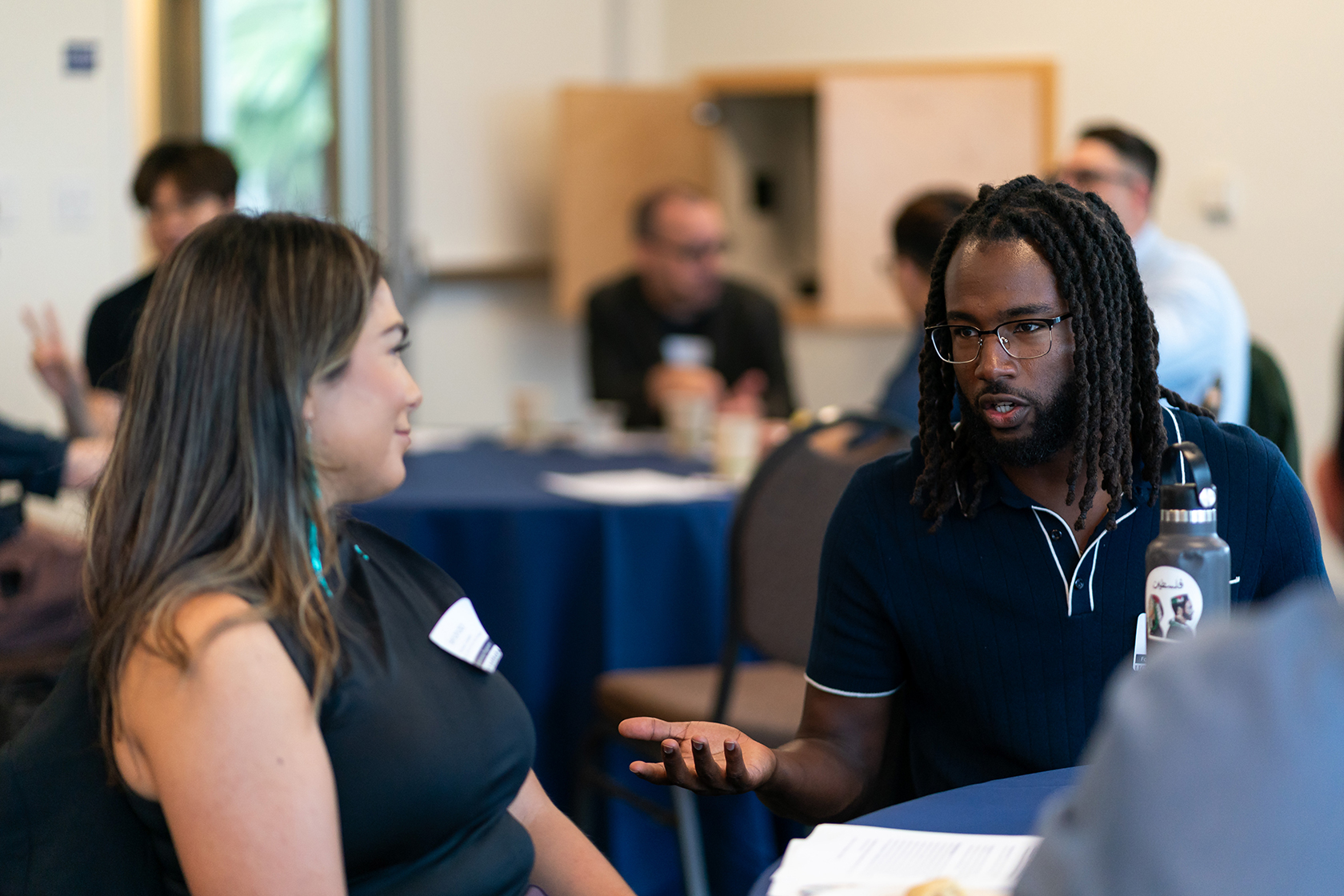 two seated people talking