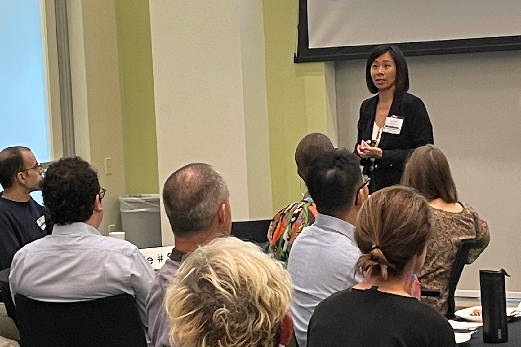 seated people with one presenter standing at the front
