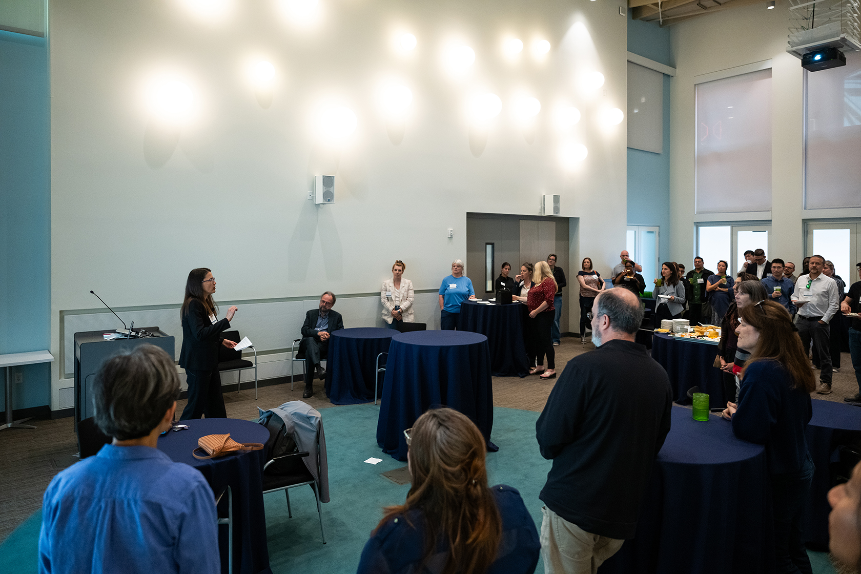 conference room with large group of people standing