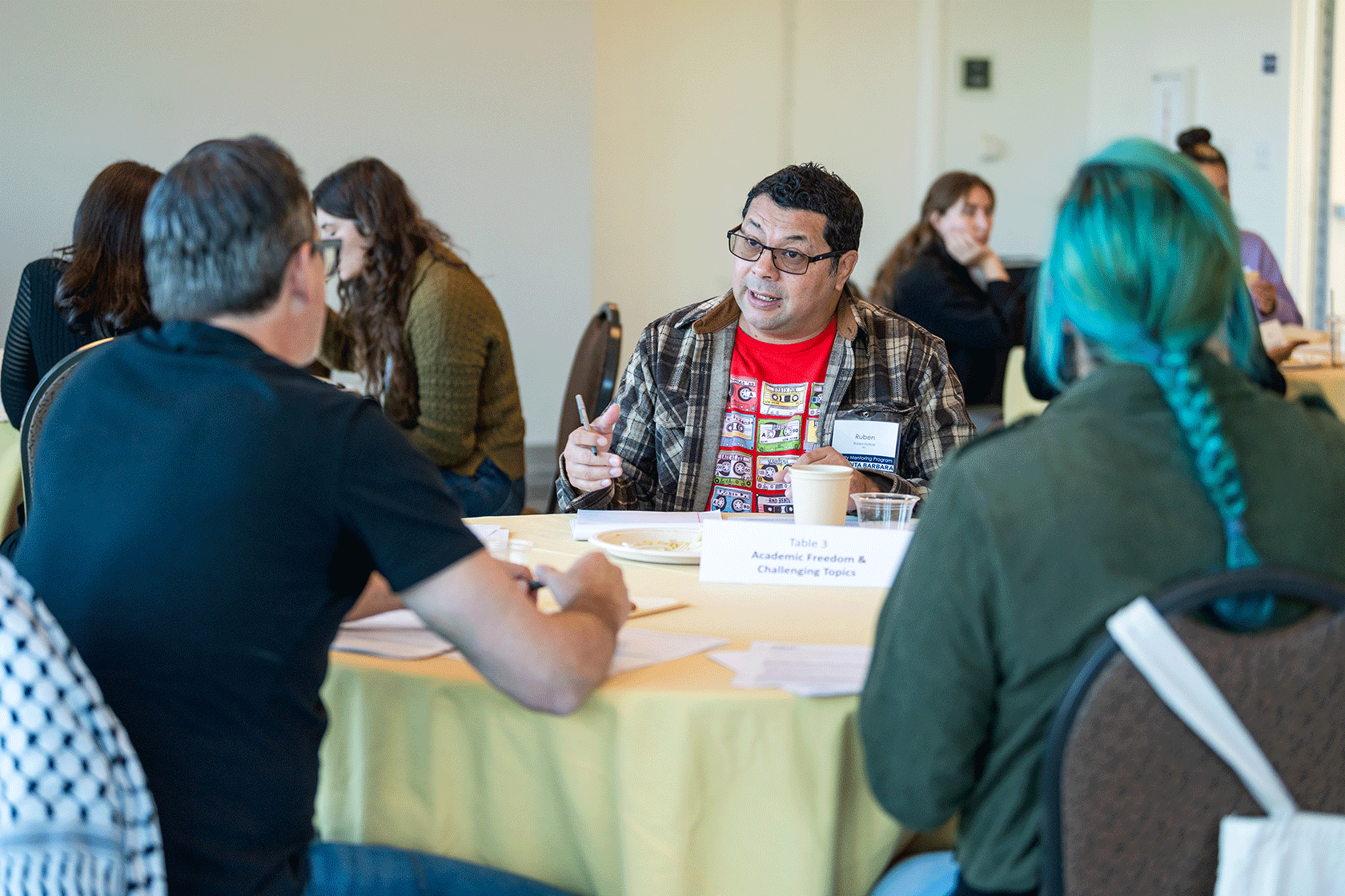 groups of people seated around circular tables conversing