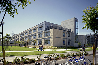 Image of UCSB Student Resource Building, with two students walking by